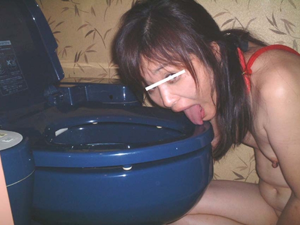 Asian licking blue toilet bowl
