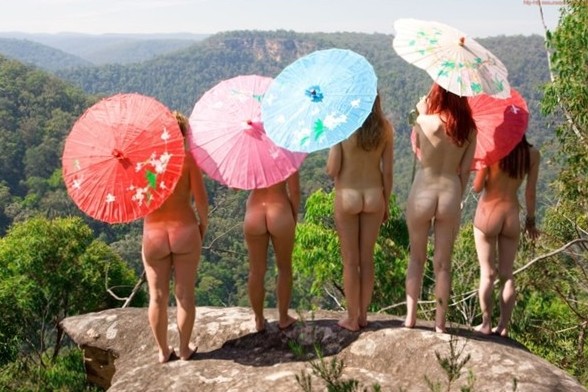 five naked girls with coloured umbrellas